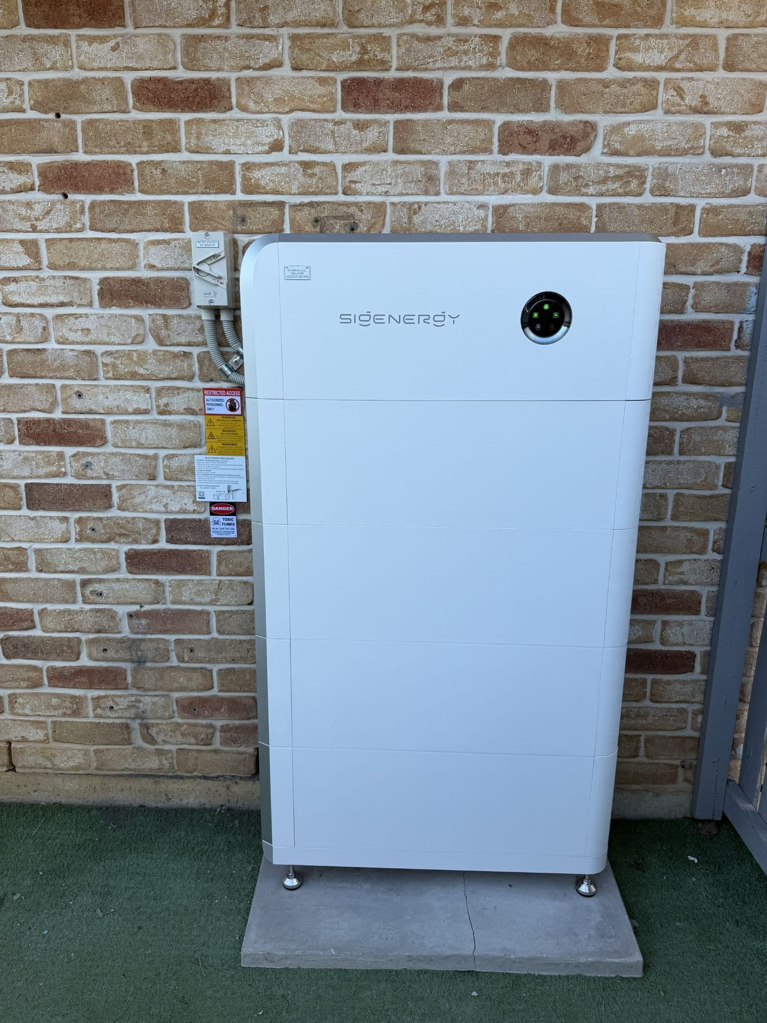 Sigenergy battery storage unit installed against an exterior wall