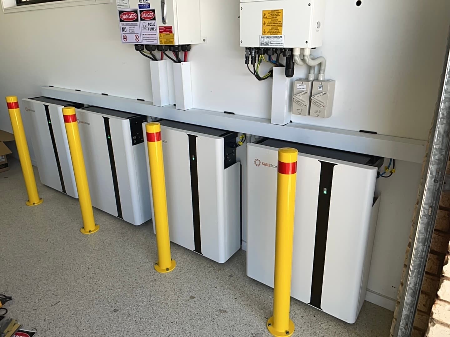 Row of SolisStorage battery units installed together in a garage