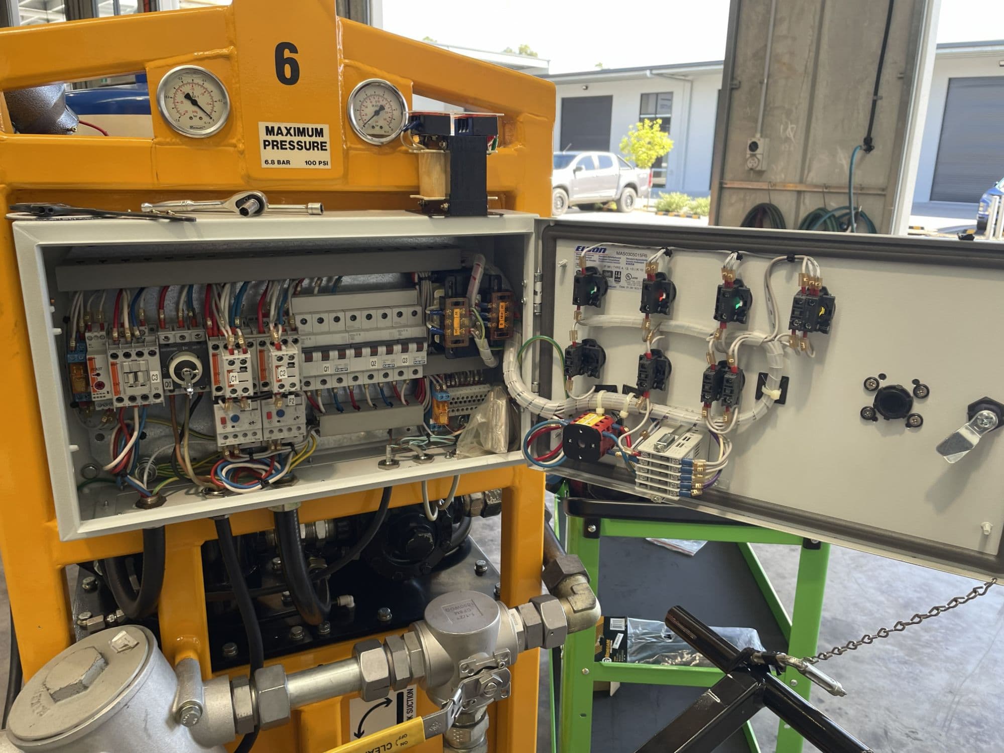 TSG Electrical technician's industrial control panel job mid-repair, with tools laid out on site